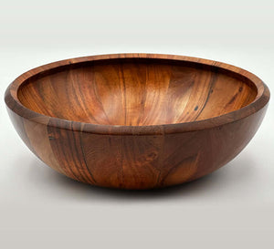 Hand carved acacia bowls showcasing rich grain and warm tones, perfect for serving and decor.