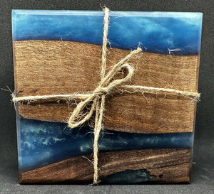 Black walnut coasters with blue epoxy beautifully arranged and tied with twine, showcasing natural wood and vibrant epoxy.