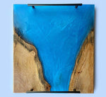 Ocean blue epoxy serving tray handcrafted from elm wood with vibrant blue epoxy accents.