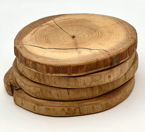 Stack of live edge wood cookies showcasing natural grain, perfect for live edge wood centerpieces and serving pieces.
