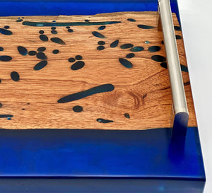 Close-up of the ocean blue live edge epoxy tray highlighting its unique wood grain and epoxy details.