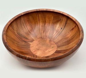 Hand carved acacia bowls showcasing unique wood grain and warm tones, perfect for serving or decor.