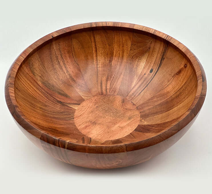 Hand carved acacia bowls showcasing unique wood grain and warm tones, perfect for serving or decor.
