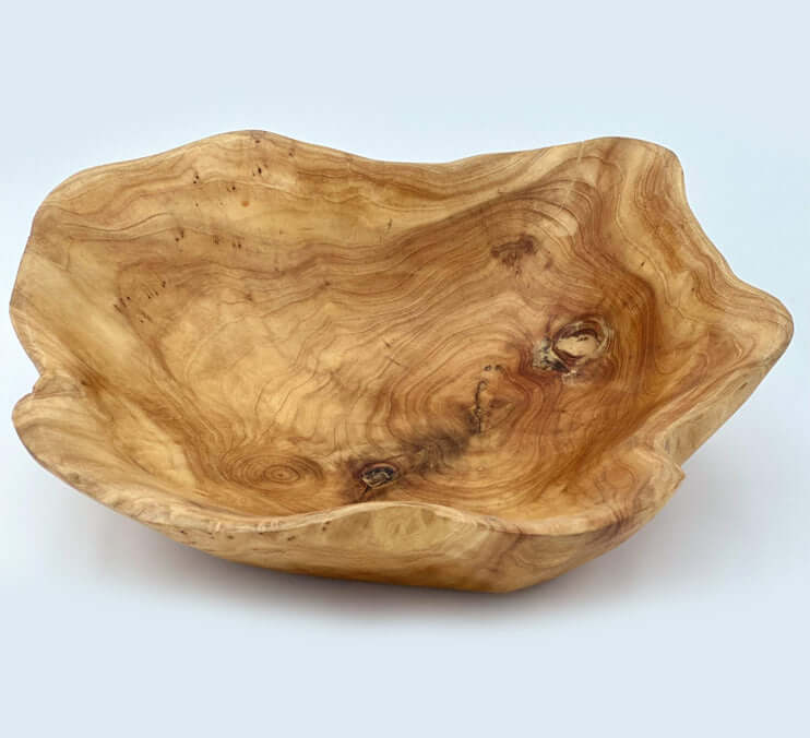 Handcrafted cedar live edge bowls showcasing unique grain patterns and organic shapes.