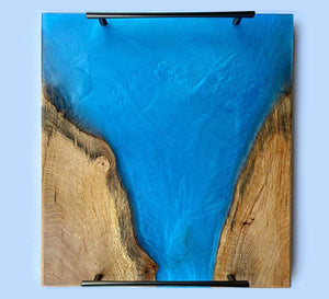 Ocean blue epoxy serving tray handcrafted from elm wood with vibrant blue epoxy accents.