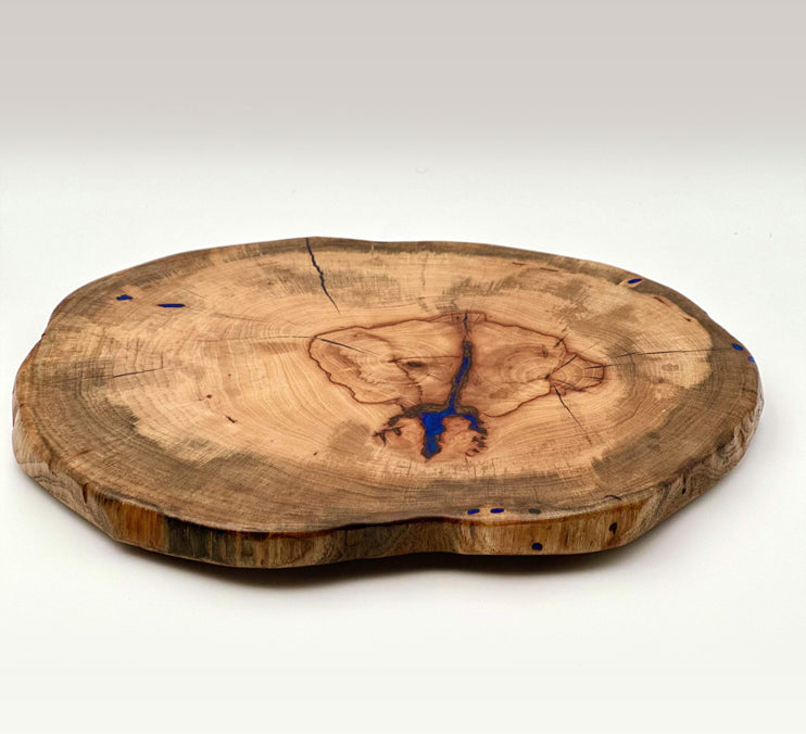Pecan live edge lazy susan showcasing natural wood grain and vibrant blue epoxy inlay.