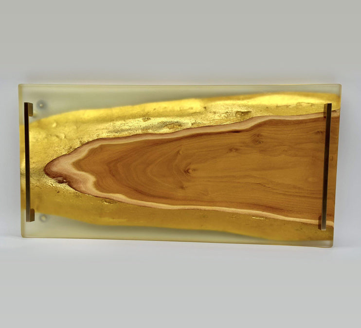 Live edge epoxy serving tray featuring Osage orange wood and gold accents for functional elegance.