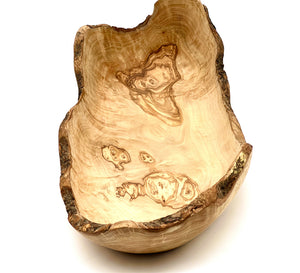 Handcrafted olive wood bowls, perfect for salads or fruit storage, showcasing unique patterns and textures.